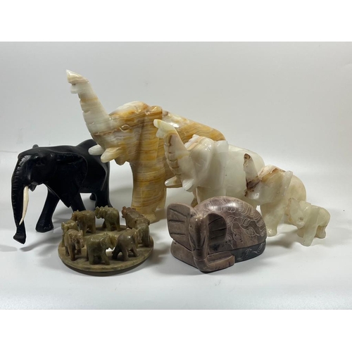 304 - A COLLECTION OF HARDSTONE ELEPHANT FIGURES TO INCLUDE GROUP, SET OF FOUR, EBONY STYE AND LIDDED EXAM... 