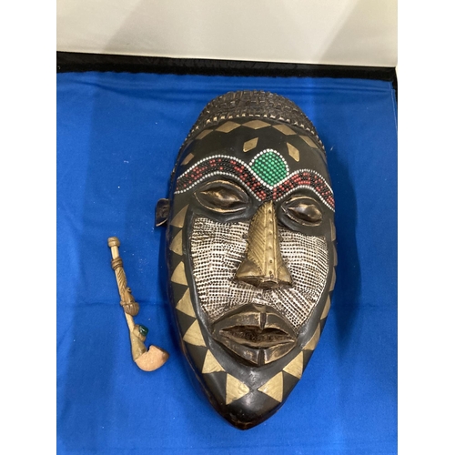 826 - AN AFRICAN TRIBAL MASK, 29CM X 15CM PLUS A VINTAGE HANDMADE TRIBAL WOODEN PIPE