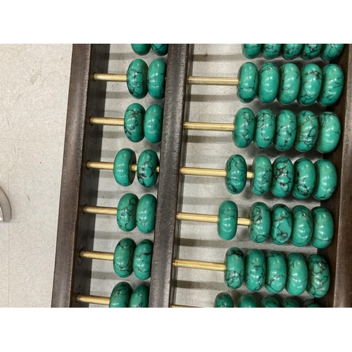 876 - A CHINESE ABACUS WITH MALACHITE COUNTERS AND SILVER COINS