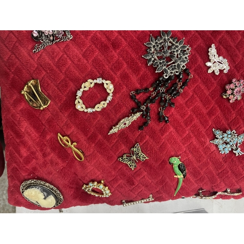 965A - A CUSHION WITH A LARGE COLLECTION OF COSTUME JEWELLERY BROOCHES