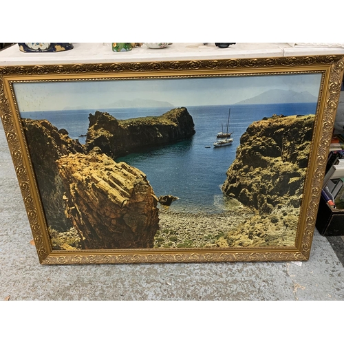 1039 - A LARGE FRAMED PRINT OF BOATS NEAR A BEACH