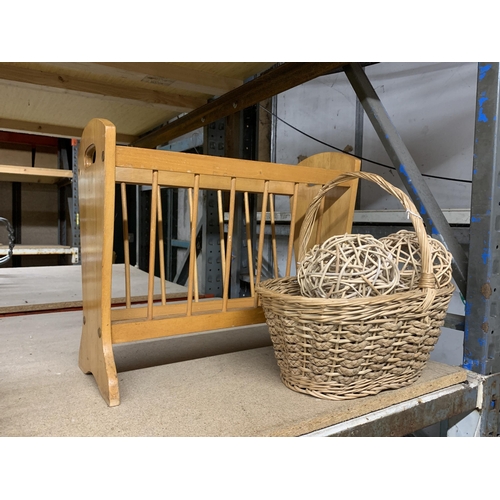 1156 - A VINTAGE MAGAZINE RACK TOGETHER WITH A WICKER BASKET CONTAINING BALLS