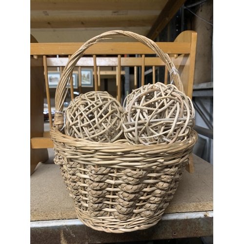 1156 - A VINTAGE MAGAZINE RACK TOGETHER WITH A WICKER BASKET CONTAINING BALLS