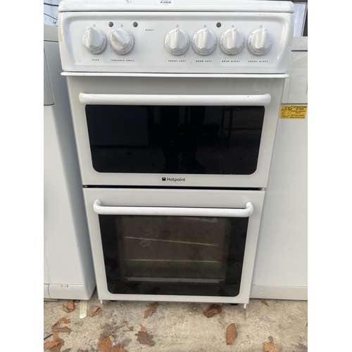 2369 - A BLACK AND WHITE HOTPOINT ELECTRIC FREESTANDING OVEN AND HOB