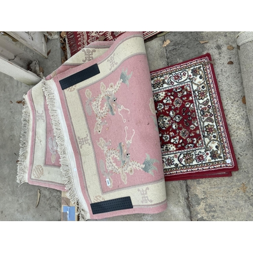 2495 - A PINK PATTERNED FRINGED RUG AND A SMALL RED PATTERNED RUG