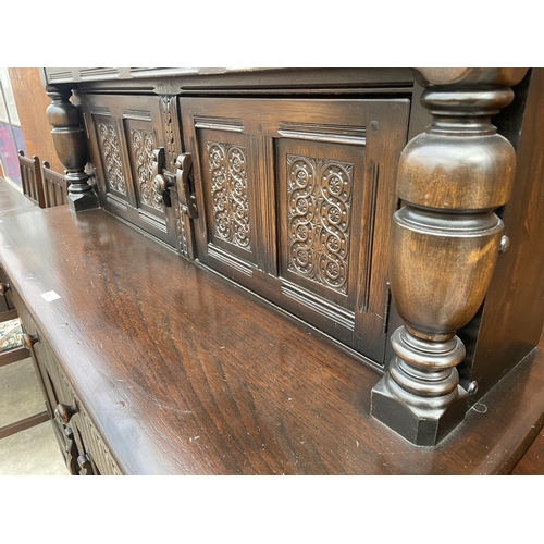 2531 - A REPRODUCTION OAK COURT CUPBOARD WITH CARVED PANEL DOORS AND DRAWERS, 51