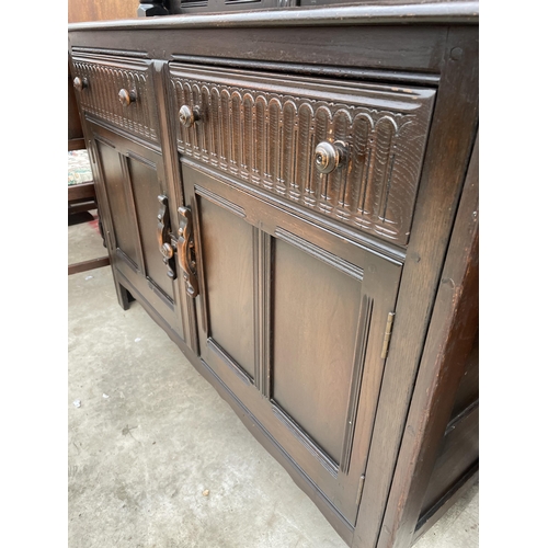 2531 - A REPRODUCTION OAK COURT CUPBOARD WITH CARVED PANEL DOORS AND DRAWERS, 51