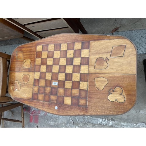 2538 - A RETRO TEAK COFFEE/GAMES TABLE WITH INLAID DRAUGHTS BOARD AND CARD SUITS