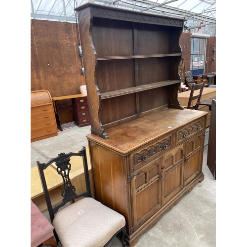 2594 - A REPRODUCTION OAK DRESSER COMPLETE WITH RACK, THE BASE ENCLOSING TWO DRAWERS AND TWO CUPBOARDS, 49