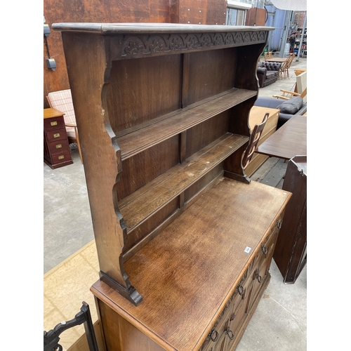 2594 - A REPRODUCTION OAK DRESSER COMPLETE WITH RACK, THE BASE ENCLOSING TWO DRAWERS AND TWO CUPBOARDS, 49