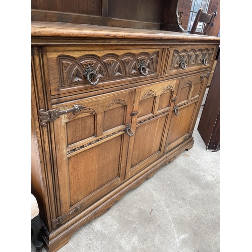 2594 - A REPRODUCTION OAK DRESSER COMPLETE WITH RACK, THE BASE ENCLOSING TWO DRAWERS AND TWO CUPBOARDS, 49