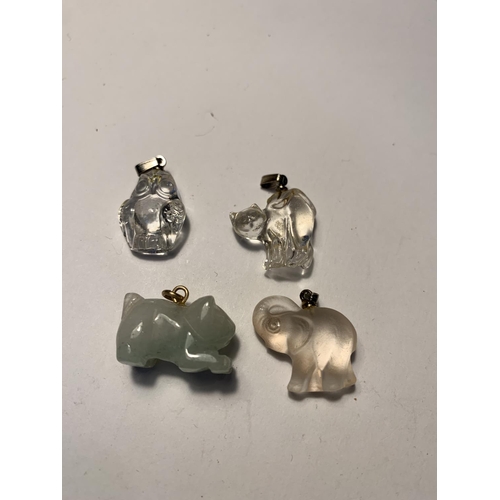 569 - EIGHT CRYSTAL AND JADE PENDANTS