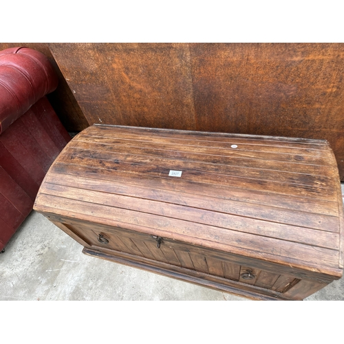 2507 - A DOMED HARDWOOD TRUNK WITH METAL BANDING AND RING HANDLES TO THE SIDES AND ENDS - 36