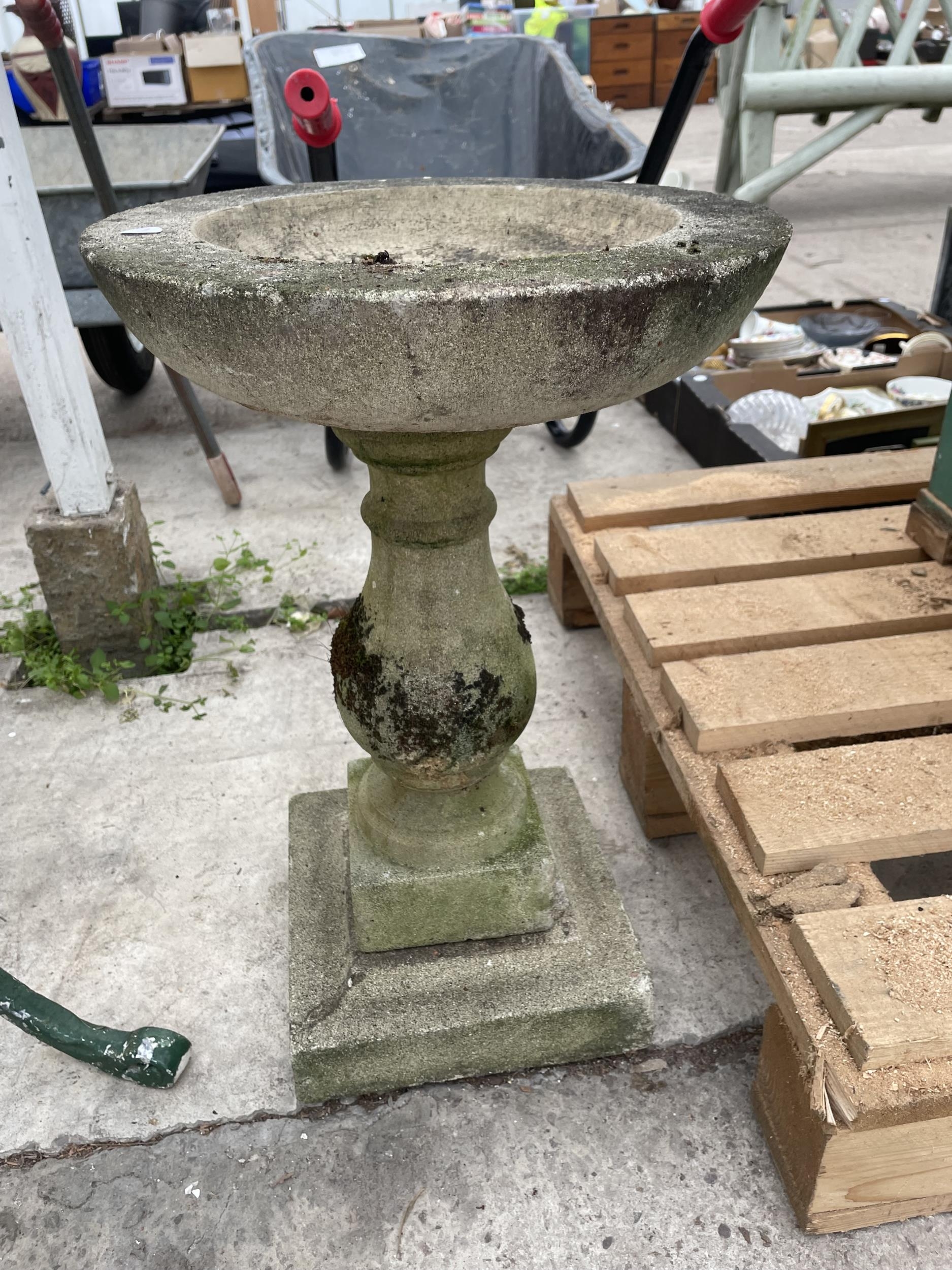 a-concrete-bird-bath-with-pedestal-base