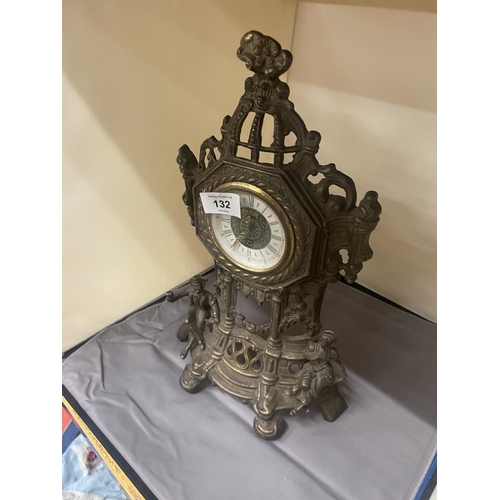 132 - AN ORNATE VINTAGE BRASS STAND UP CLOCK, HEIGHT 36CM