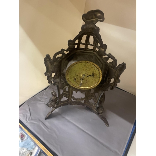 132 - AN ORNATE VINTAGE BRASS STAND UP CLOCK, HEIGHT 36CM