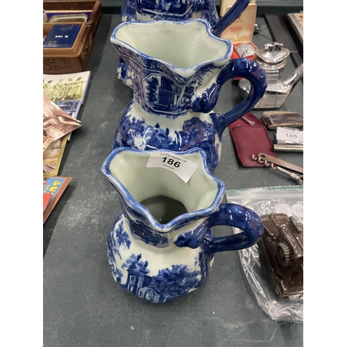 186 - FOUR MATCHING, GRADUATING BLUE AND WHITE IRONSTONE JUGS, LARGEST HEIGHT 23CM