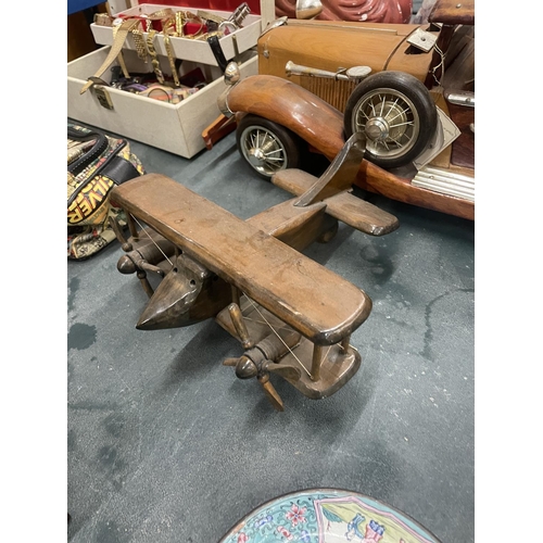 201 - A LARGE WOODEN MODEL OF A CAR PLUS A SMALLER MODEL OF A BI-PLANE