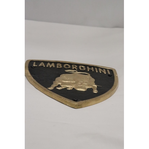 212 - A TRIANGULAR BLACK AND GOLD CAST METAL LAMBORGHINI SIGN, 21CM X 18CM