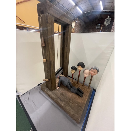 22 - A MODEL OF A GUILLOTINE WITH FOUR VARIOUS HEADS