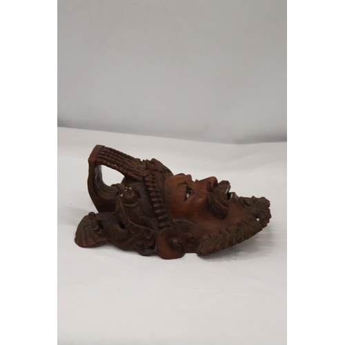 224 - AN ASIAN STYLE CARVED WOODEN MASK