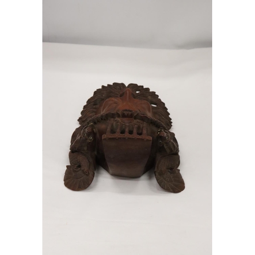 224 - AN ASIAN STYLE CARVED WOODEN MASK