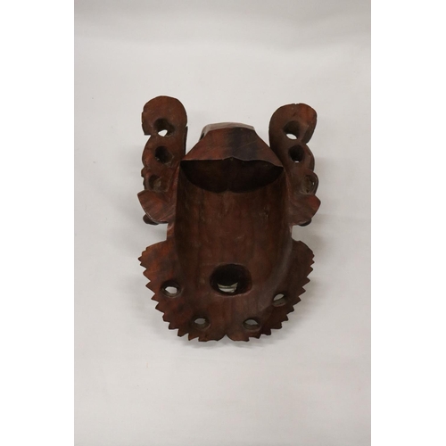 224 - AN ASIAN STYLE CARVED WOODEN MASK