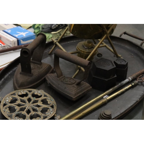 261 - A VINTAGE LOT TO INCLUDE A LARGE METAL TRAY, A BRASS SPIRIT KETTLE AND BURNER, FLAT IRONS, WEIGHTS, ... 