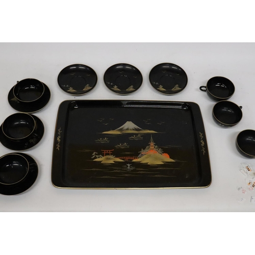 471 - AN ORIENTAL HANDPAINTED, LACQUERED TRAY WITH SIX CUPS AND SAUCERS