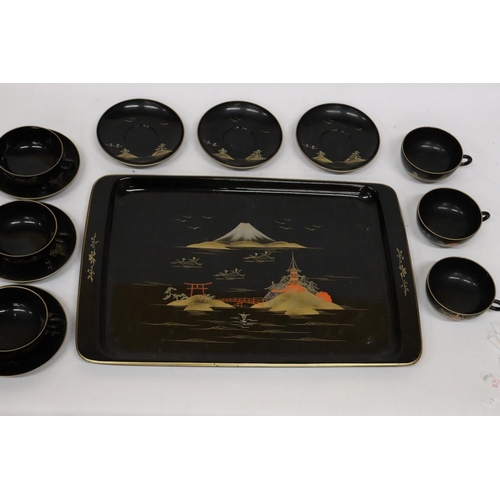 471 - AN ORIENTAL HANDPAINTED, LACQUERED TRAY WITH SIX CUPS AND SAUCERS