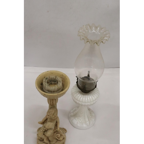 486 - A WHITE BASED GLASS FLUTED SHADE OIL LAMP AND A CHERUB DESIGN FLOWER ARRANGIMG STAND