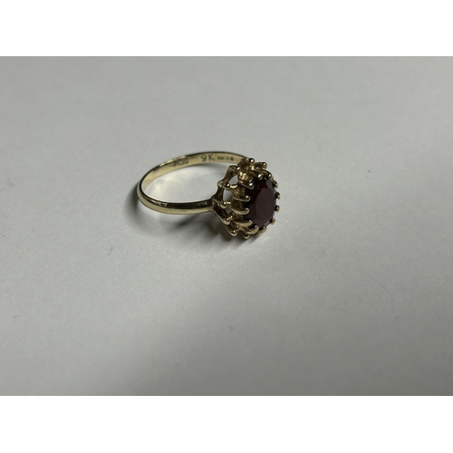 514 - A 9CT YELLOW GOLD AND GARNET RING, SIZE K