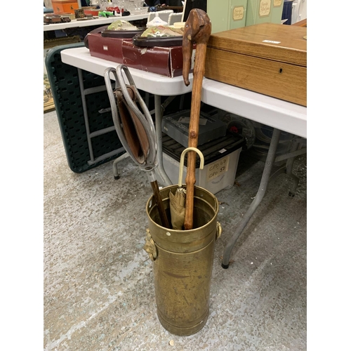 762 - A VINTAGE BRASS STICK/UMBRELLA STAND WITH LION HANDLES, A SHOOTING STICK AND ELEPHANT HEADED WALKING... 