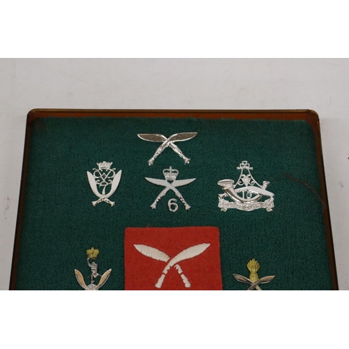 402 - A CASED COLLECTION OF GURKHA BADGES