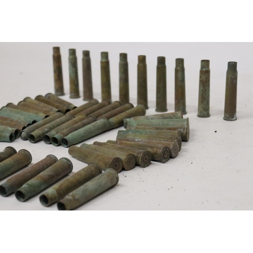 407 - A COLLECTION OF APPROXIMATELY FIFTY-TWO WORLD .303 BRASS SPENT CARTRIDGES