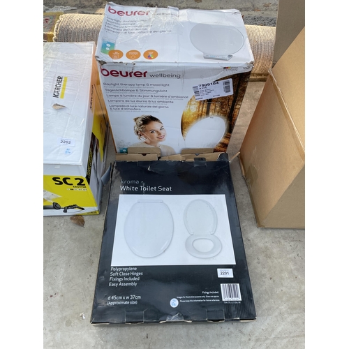 2201 - A BOXED TOILET SEAT AND A BEURER WELLBEING THERAPY LAMP