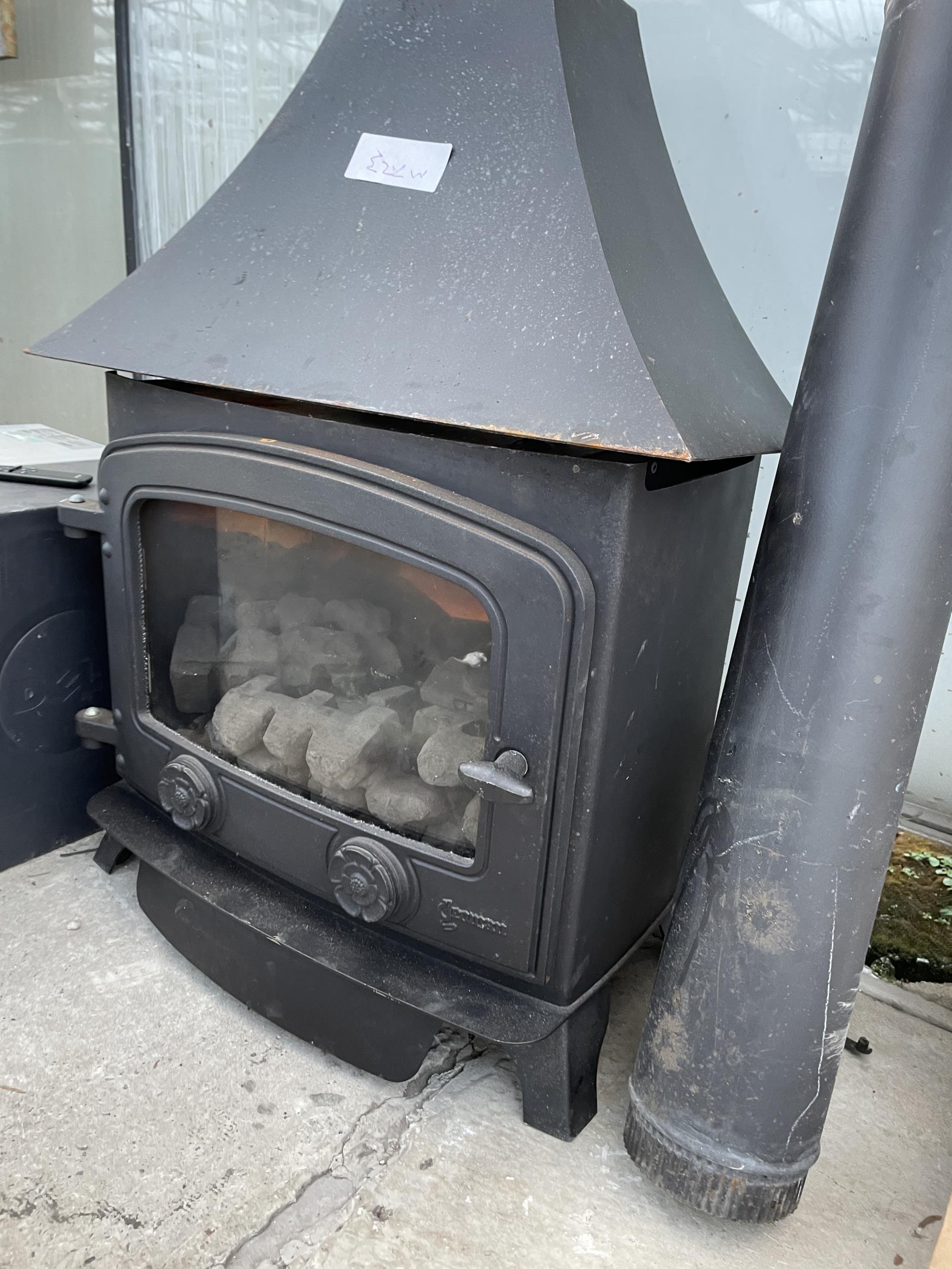 A CAST IRON LOG BURNER WITH FLU