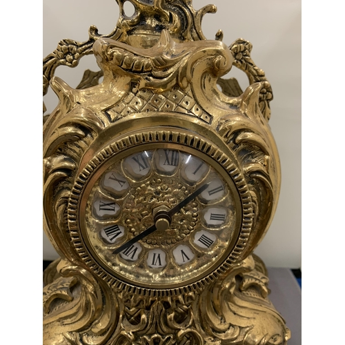 44 - AN ORNATE GILT MANTLE CLOCK WITH ROMAN NUMERALS