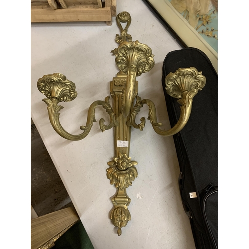 70A - A BRASS WALL MOUNTED THREE BRANCH CANDELABRA