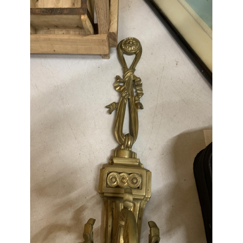 70A - A BRASS WALL MOUNTED THREE BRANCH CANDELABRA