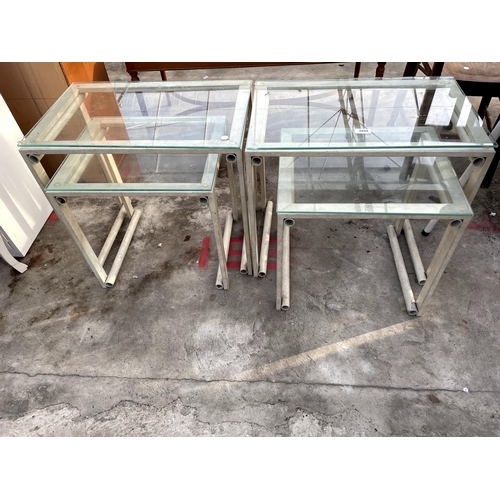 2695 - TWO SETS OF TABLE NEST WITH GLASS TOPS, ON TUBULAR FRAMES