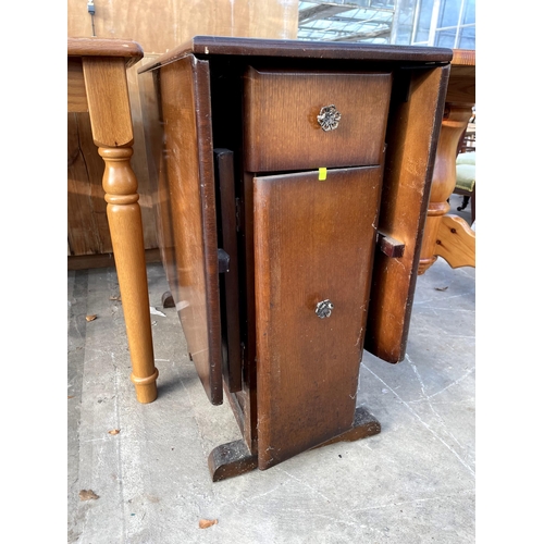 2712 - A JARMAN AND PLATT MID 20TH CENTURY OAK DROP LEAF DINING TABLE ENCLOSING TWO DRAWERS AND TWO CUPBOAR... 