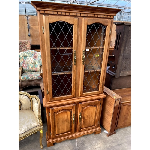 2716 - A MODERN BEECH CORNER CUPBOARD WITH GLAZED AND LEADED UPPER PORTION