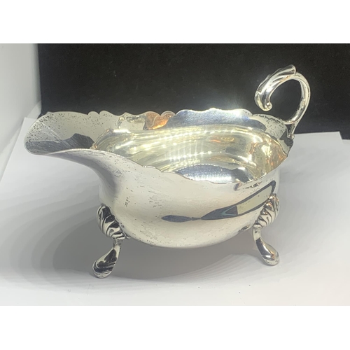 50A - A HALLMARKED LONDON SILVER THREE LEGGED JUG