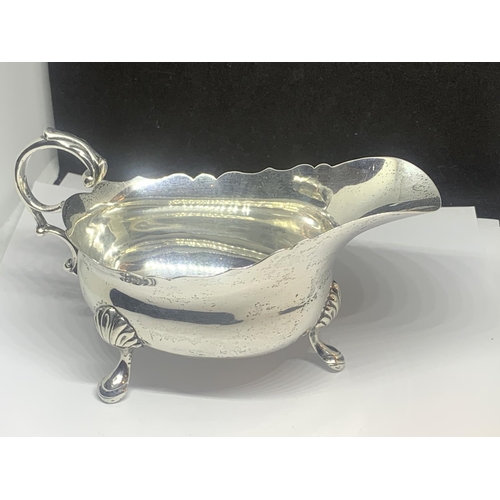 50A - A HALLMARKED LONDON SILVER THREE LEGGED JUG