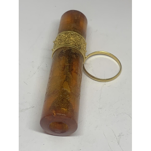 667 - AN AMBER CHEROOT HOLDER WITH A DECORATIVE TESTED TO 9 CARAT GOLD COLLAR