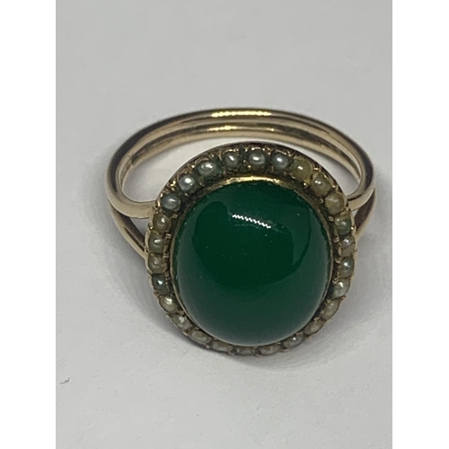 674 - A YELLOW METAL RING WITH GREEN STONE AND PEARLS GROSS WEIGHT 5 GRAMS SIZE M/N