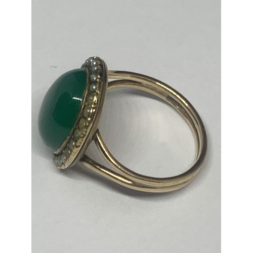 674 - A YELLOW METAL RING WITH GREEN STONE AND PEARLS GROSS WEIGHT 5 GRAMS SIZE M/N