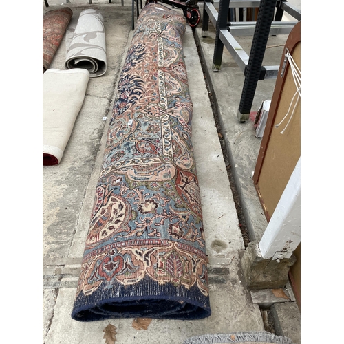 2487 - A LARGE BLUE PATTERNED FRINGED RUG