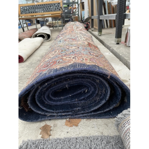 2487 - A LARGE BLUE PATTERNED FRINGED RUG